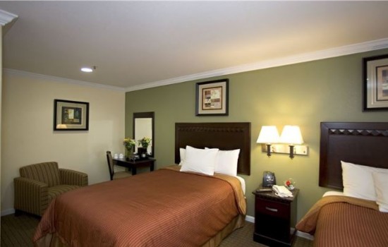 Welcome To North Bay Inn - Two Double Beds With Seating And Vanity Area.